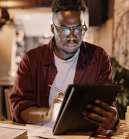 Person checking their financials on a tablet.